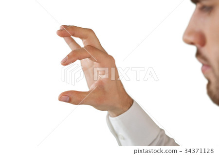 Cropped image of businessman looking at invisible product Cropped image of businessman looking at invisible product 34371128