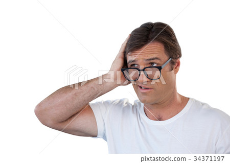 Confused mature man wearing eyeglasses looking away 34371197