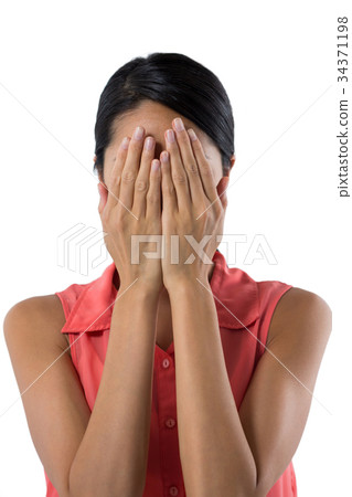 Woman covering her eyes with hand against white background Woman covering her eyes with hand against white background 34371198