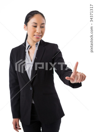 Businesswoman pressing an invisible virtual screen 34371317