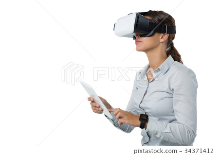 Female executive using virtual reality headset 34371412
