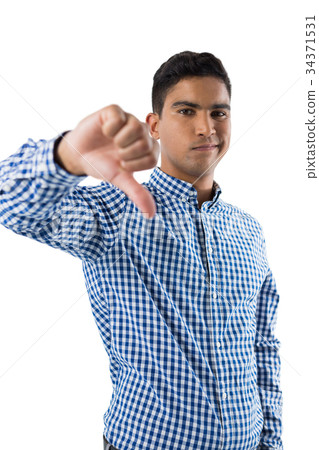 Portrait of displeased man showing thumb sign 34371531