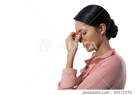 Tensed female executive against white background 34371570