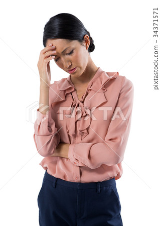 Tensed female executive standing against white background Tensed female executive standing against white background 34371571
