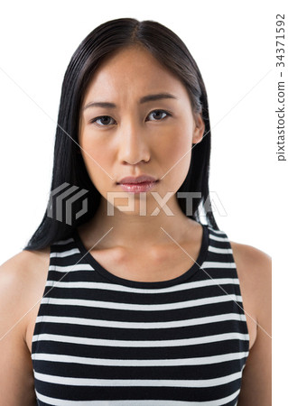 Depressed woman standing against white background 34371592