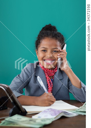 Smiling businesswoman talking on mobile phone 34371598