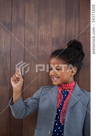 Smiling businesswoman touching invisible interface Smiling businesswoman touching invisible interface 34371608