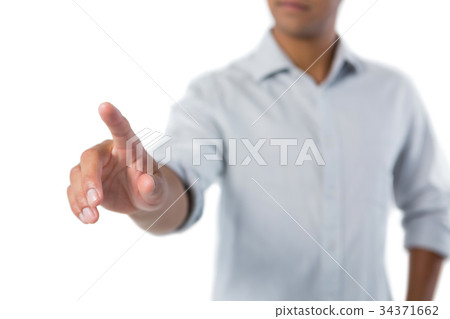 Man pretending to touch an invisible screen against white background 34371662