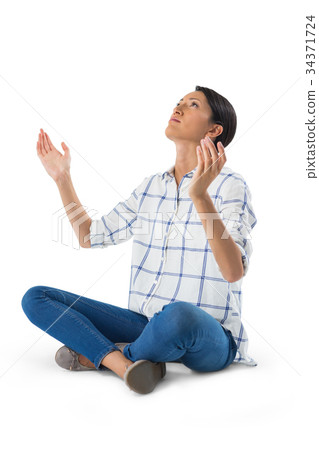 Woman praying against white background 34371724