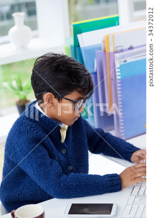 Side view of businessman using desktop computer at desk 34372012