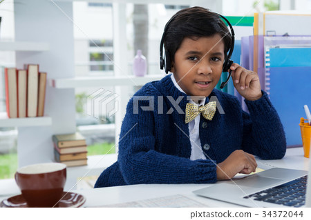 Businessman looking away while using headset 34372044