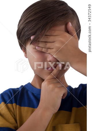 Cute boy covering his eyes 34372549