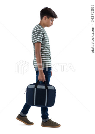 Teenage boy walking with bag 34372895