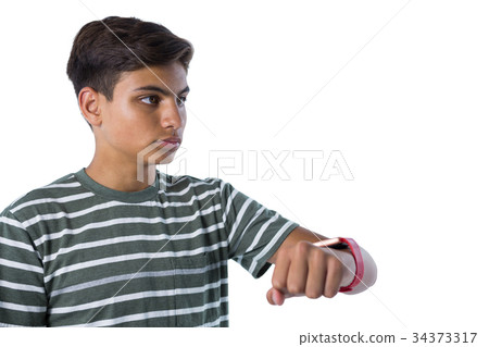 Teenage boy looking at his smartwatch 34373317