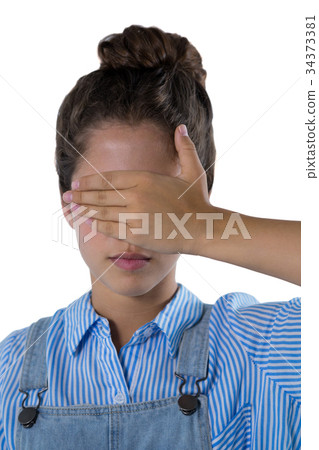 Teenage girl covering her eyes Teenage girl covering her eyes 34373381