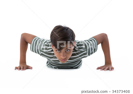 Teenage boy performing push ups 34373408