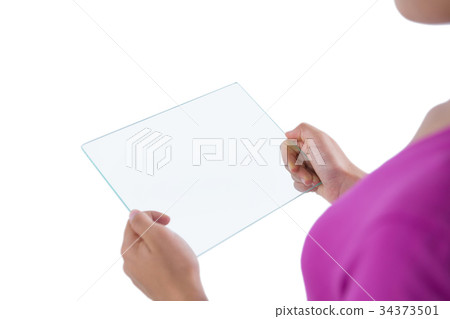 Girl using glass digital tablet against white background Girl using glass digital tablet against white background 34373501