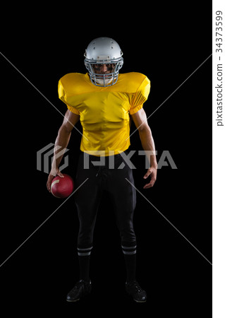 American football player holding a ball in one hand 34373599