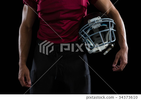American football player holding a head gear 34373610