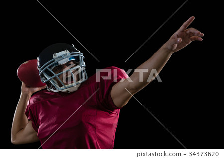Energetic American football player aiming a ball 34373620
