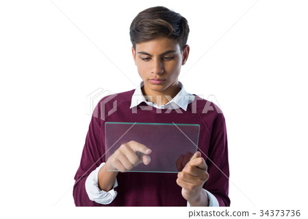 Teenage boy using glass digital tablet against white background Teenage boy using glass digital tablet against white background 34373736
