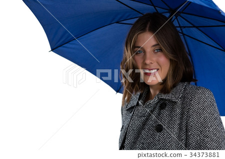 Portrait of smiling woman with blue umbrella Portrait of smiling woman with blue umbrella 34373881