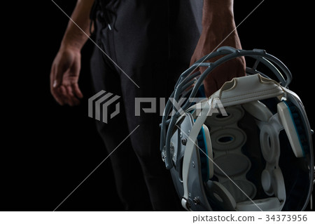 American football player holding a head gear 34373956