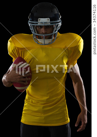 American football player holding a ball in his hand 34374116