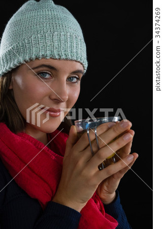Portrait of woman holding coffee cup Portrait of woman holding coffee cup 34374269