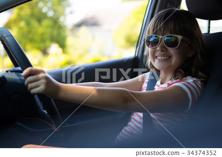 Teenage girl driving a car 34374352