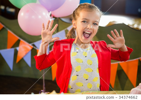 Portrait of excited girl in birthday party 34374662
