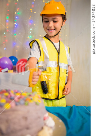 Boy pretending as a worker during birthday party Boy pretending as a worker during birthday party 34374818