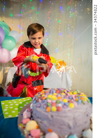 Cute boy pretending to be a fireman during birthday party 34374822