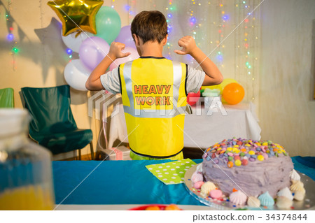 Boy gesturing to the text on protective workwear Boy gesturing to the text on protective workwear 34374844