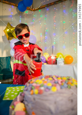 Cute boy pretending to be a fireman during birthday party Cute boy pretending to be a fireman during birthday party 34374965