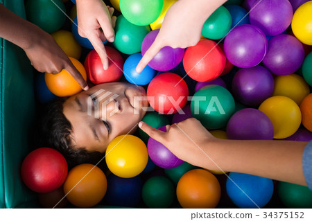 Cropped hand on children pointing on boy Cropped hand on children pointing on boy 34375152