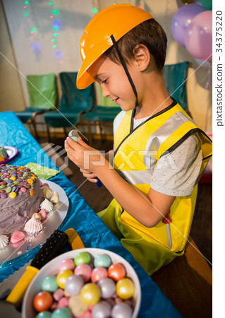 Boy pretending as a worker during birthday party 34375220