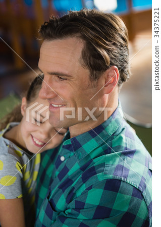 Close-up of cute daughter embracing father Close-up of cute daughter embracing father 34375221
