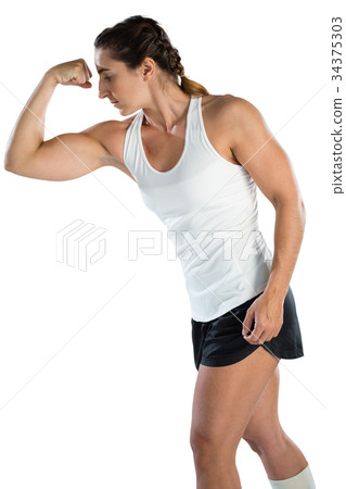 Female rugby player flexing muscles Female rugby player flexing muscles 34375303