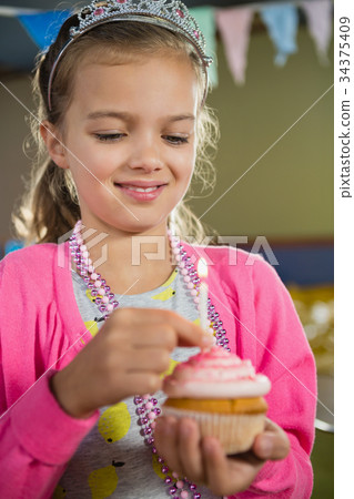 Birthday girl holding a cupcake Birthday girl holding a cupcake 34375409
