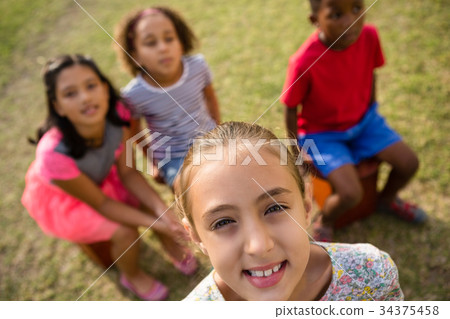 High angle view of children sitting in yard 34375458
