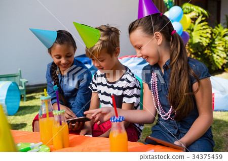 Happy children using mobile phone 34375459