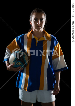 Portrait of female athlete in sports clothing holding rugby ball 34375488