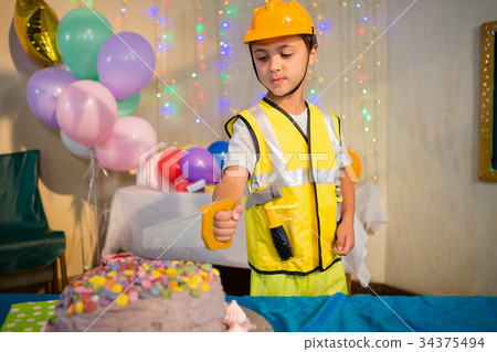 Boy pretending as a worker during birthday party Boy pretending as a worker during birthday party 34375494