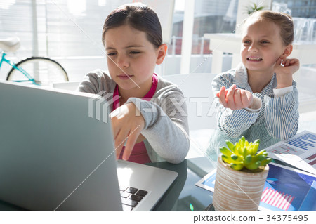 Kids as business executives discussing over laptop Kids as business executives discussing over laptop 34375495