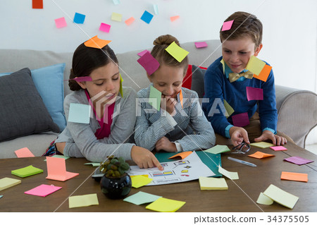 Kids as business executives playing with sticky notes 34375505