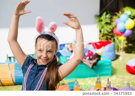 Portrait of smiling girl with arms raised Portrait of smiling girl with arms raised 34375983