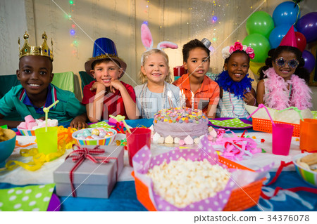 Portrait of smiling children at table 34376078