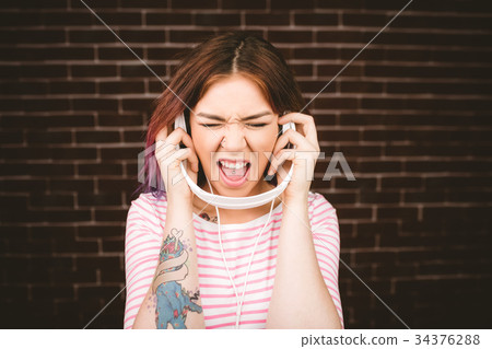 Woman listening music on headphones 34376288