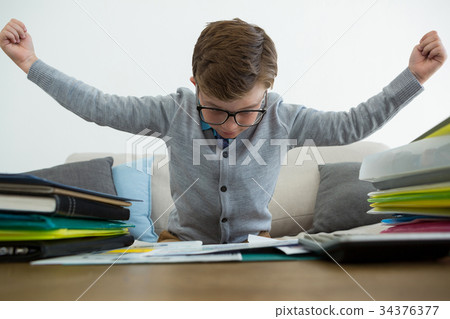 Frustrated businessman with arms outstretched sitting on sofa Frustrated businessman with arms outstretched sitting on sofa 34376377